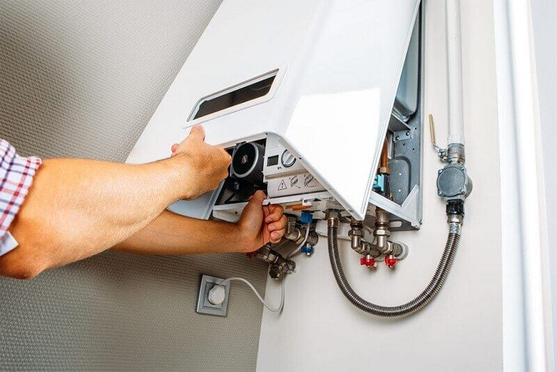Hot water plumber working on repair in Penrith